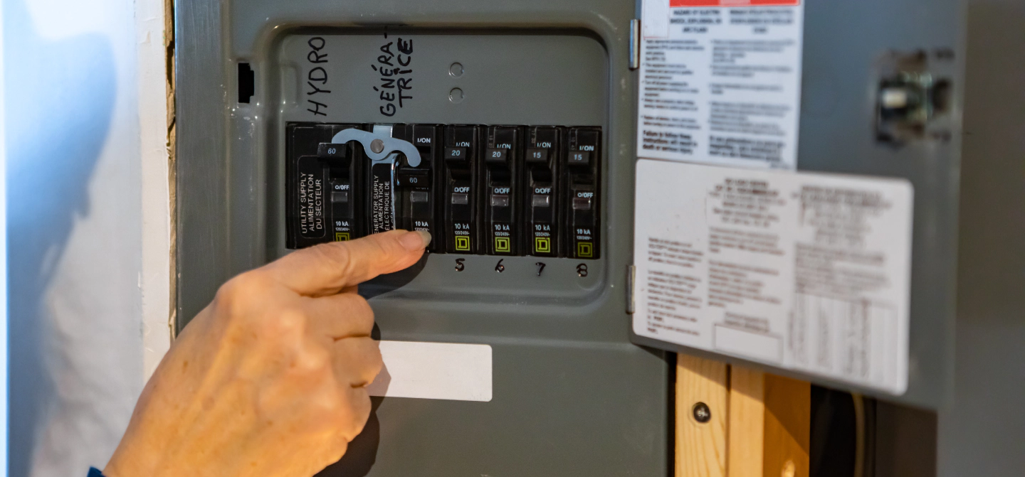hand touching switches on electrical panel kansas city ks